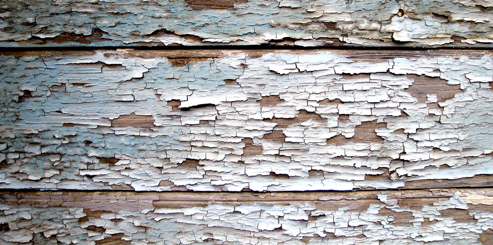 Paint peeling on the side of a house